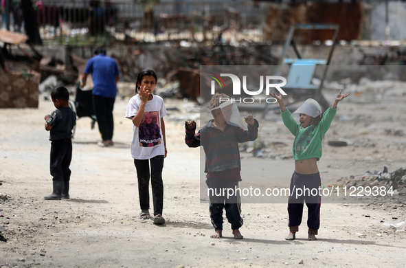 Displaced Palestinian children are playing inside a school where they have taken refuge to set up shelter amid the ongoing conflict between...