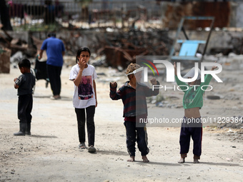 Displaced Palestinian children are playing inside a school where they have taken refuge to set up shelter amid the ongoing conflict between...