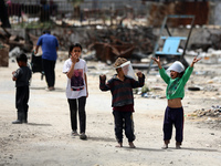 Displaced Palestinian children are playing inside a school where they have taken refuge to set up shelter amid the ongoing conflict between...