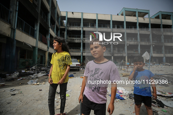 Displaced Palestinian children are playing inside a school where they have taken refuge to set up shelter amid the ongoing conflict between...