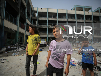 Displaced Palestinian children are playing inside a school where they have taken refuge to set up shelter amid the ongoing conflict between...