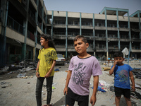 Displaced Palestinian children are playing inside a school where they have taken refuge to set up shelter amid the ongoing conflict between...