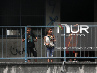 Displaced Palestinian children are playing inside a school where they have taken refuge to set up shelter amid the ongoing conflict between...