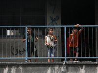 Displaced Palestinian children are playing inside a school where they have taken refuge to set up shelter amid the ongoing conflict between...