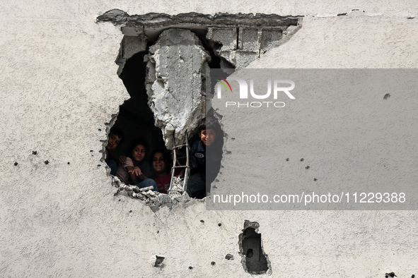 Displaced Palestinian children are playing inside a school where they have taken refuge to set up shelter amid the ongoing conflict between...