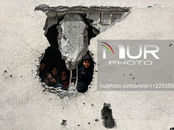 Displaced Palestinian children are playing inside a school where they have taken refuge to set up shelter amid the ongoing conflict between...