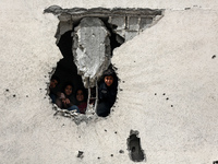 Displaced Palestinian children are playing inside a school where they have taken refuge to set up shelter amid the ongoing conflict between...