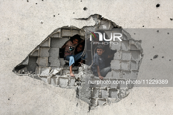 Displaced Palestinian children are playing inside a school where they have taken refuge to set up shelter amid the ongoing conflict between...