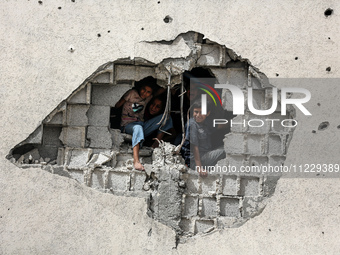 Displaced Palestinian children are playing inside a school where they have taken refuge to set up shelter amid the ongoing conflict between...