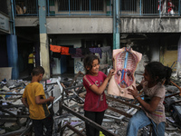 Displaced Palestinian children are playing inside a school where they have taken refuge to set up shelter amid the ongoing conflict between...