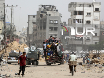 Displaced Palestinians are setting up shelter after returning to Khan Yunis in the southern Gaza Strip, amid the ongoing conflict between Is...