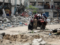 Displaced Palestinians are setting up shelter after returning to Khan Yunis in the southern Gaza Strip, amid the ongoing conflict between Is...