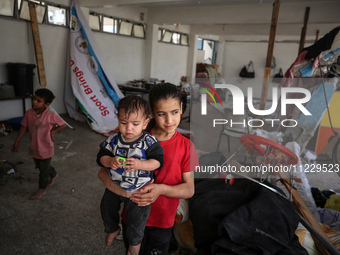 Displaced Palestinians are taking refuge inside a school to set up shelter amid the ongoing conflict between Israel and the Palestinian mili...