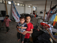 Displaced Palestinians are taking refuge inside a school to set up shelter amid the ongoing conflict between Israel and the Palestinian mili...