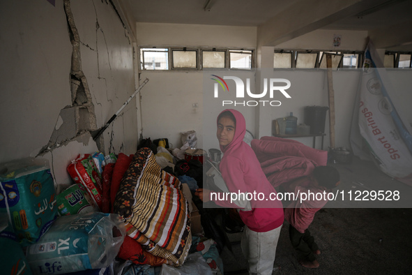 Displaced Palestinians are taking refuge inside a school to set up shelter amid the ongoing conflict between Israel and the Palestinian mili...