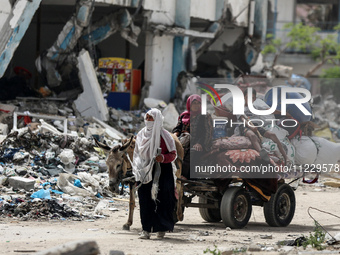 Displaced Palestinians are setting up shelter after returning to Khan Yunis in the southern Gaza Strip, amid the ongoing conflict between Is...