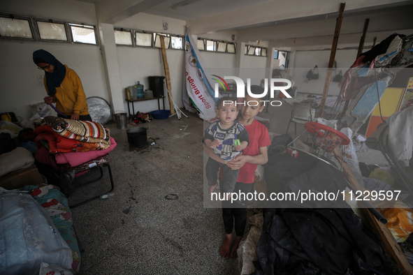 Displaced Palestinians are taking refuge inside a school to set up shelter amid the ongoing conflict between Israel and the Palestinian mili...