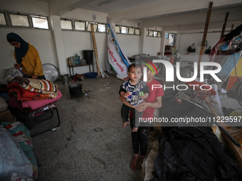 Displaced Palestinians are taking refuge inside a school to set up shelter amid the ongoing conflict between Israel and the Palestinian mili...