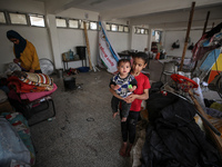 Displaced Palestinians are taking refuge inside a school to set up shelter amid the ongoing conflict between Israel and the Palestinian mili...