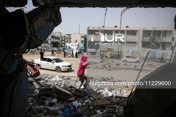 Displaced Palestinians are taking refuge inside a school to set up shelter amid the ongoing conflict between Israel and the Palestinian mili...