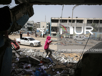 Displaced Palestinians are taking refuge inside a school to set up shelter amid the ongoing conflict between Israel and the Palestinian mili...