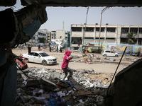 Displaced Palestinians are taking refuge inside a school to set up shelter amid the ongoing conflict between Israel and the Palestinian mili...