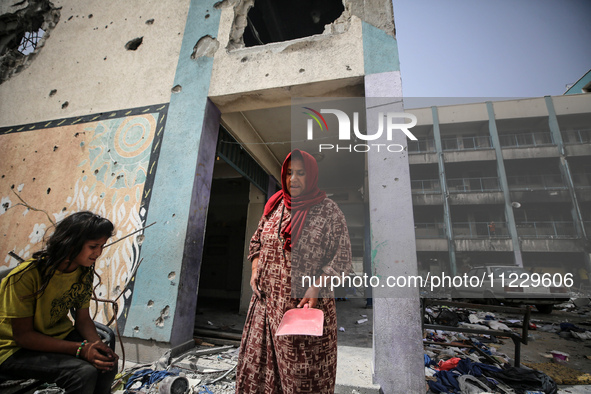 Displaced Palestinians are taking refuge inside a school to set up shelter amid the ongoing conflict between Israel and the Palestinian mili...