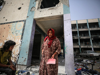 Displaced Palestinians are taking refuge inside a school to set up shelter amid the ongoing conflict between Israel and the Palestinian mili...