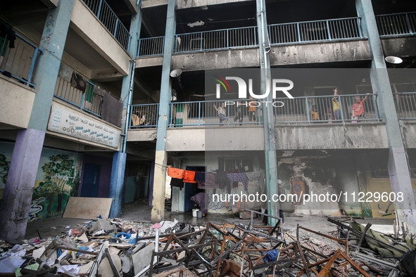 Displaced Palestinians are taking refuge inside a school to set up shelter amid the ongoing conflict between Israel and the Palestinian mili...