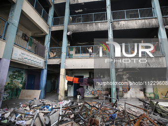 Displaced Palestinians are taking refuge inside a school to set up shelter amid the ongoing conflict between Israel and the Palestinian mili...