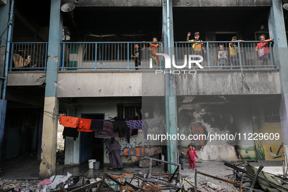 Displaced Palestinians are taking refuge inside a school to set up shelter amid the ongoing conflict between Israel and the Palestinian mili...