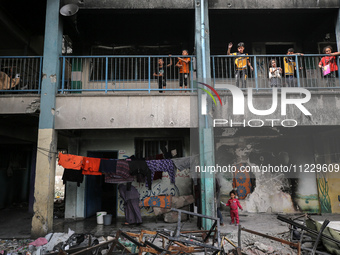 Displaced Palestinians are taking refuge inside a school to set up shelter amid the ongoing conflict between Israel and the Palestinian mili...