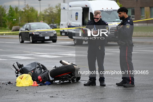 Police are examining evidence at the crash site while the motorcycle is lying on the roadway. A motor vehicle crash involving a Nissan Rogue...