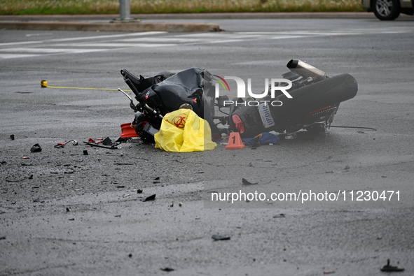 A motorcycle is at the crash site where a motor vehicle accident involving a Nissan Rogue and a motorcycle is leaving the motorcyclist in li...