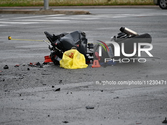 A motorcycle is at the crash site where a motor vehicle accident involving a Nissan Rogue and a motorcycle is leaving the motorcyclist in li...