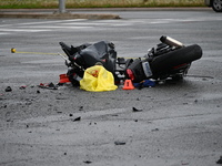 A motorcycle is at the crash site where a motor vehicle accident involving a Nissan Rogue and a motorcycle is leaving the motorcyclist in li...