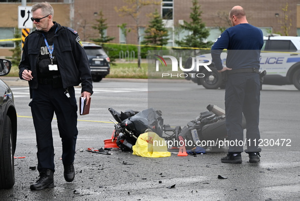 A motorcycle is at the crash site where a motor vehicle accident involving a Nissan Rogue and a motorcycle is leaving the motorcyclist in li...