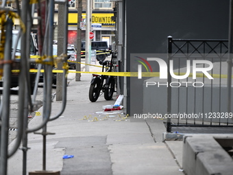 An investigator is placing evidence markers at the scene of a slashing attack where they have found evidence and blood on the ground. Police...