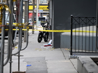 An investigator is placing evidence markers at the scene of a slashing attack where they have found evidence and blood on the ground. Police...