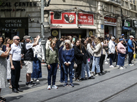 People are standing still as a siren sounds, marking Israel's Memorial Day, when the country commemorates fallen soldiers of Israel's wars a...