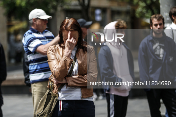 People are standing still as a siren sounds, marking Israel's Memorial Day, when the country commemorates fallen soldiers of Israel's wars a...