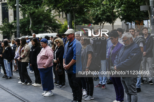 People are standing still as a siren sounds, marking Israel's Memorial Day, when the country commemorates fallen soldiers of Israel's wars a...