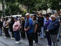 People are standing still as a siren sounds, marking Israel's Memorial Day, when the country commemorates fallen soldiers of Israel's wars a...