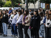 People are standing still as a siren sounds, marking Israel's Memorial Day, when the country commemorates fallen soldiers of Israel's wars a...