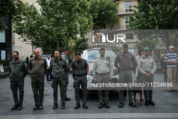 People are standing still as a siren sounds, marking Israel's Memorial Day, when the country commemorates fallen soldiers of Israel's wars a...