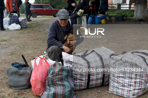 A man with a dog is evacuating from the city of Vovchansk, which is constantly subjected to Russian shelling, in the Kharkiv region, northea...