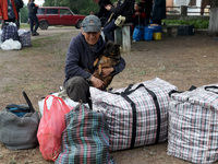 A man with a dog is evacuating from the city of Vovchansk, which is constantly subjected to Russian shelling, in the Kharkiv region, northea...