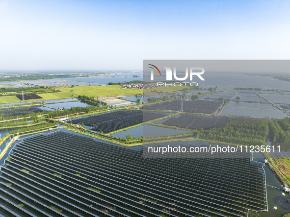 Photovoltaic panels are lining up in an ecological fish pond in Quyang town, Lianyungang, China, on May 13, 2024. 