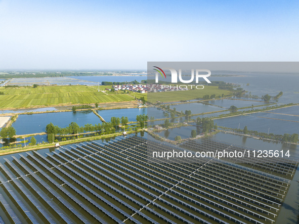 Photovoltaic panels are lining up in an ecological fish pond in Quyang town, Lianyungang, China, on May 13, 2024. 