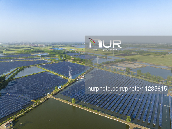 Photovoltaic panels are lining up in an ecological fish pond in Quyang town, Lianyungang, China, on May 13, 2024. 